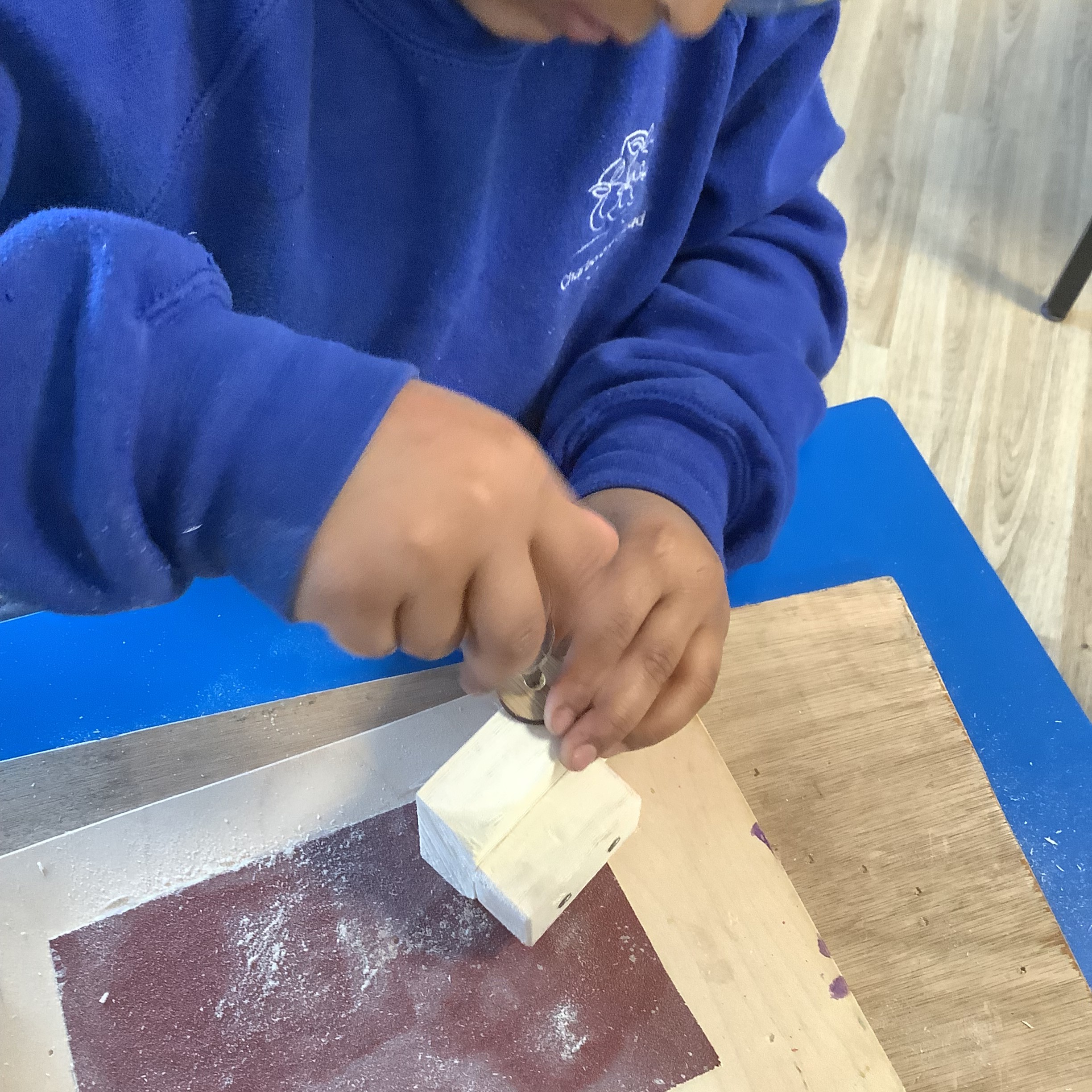 Children building wooden buggies during a school workshop